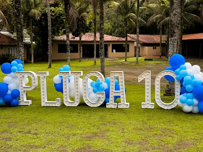 Letreiro de aniversário iluminado no gramado